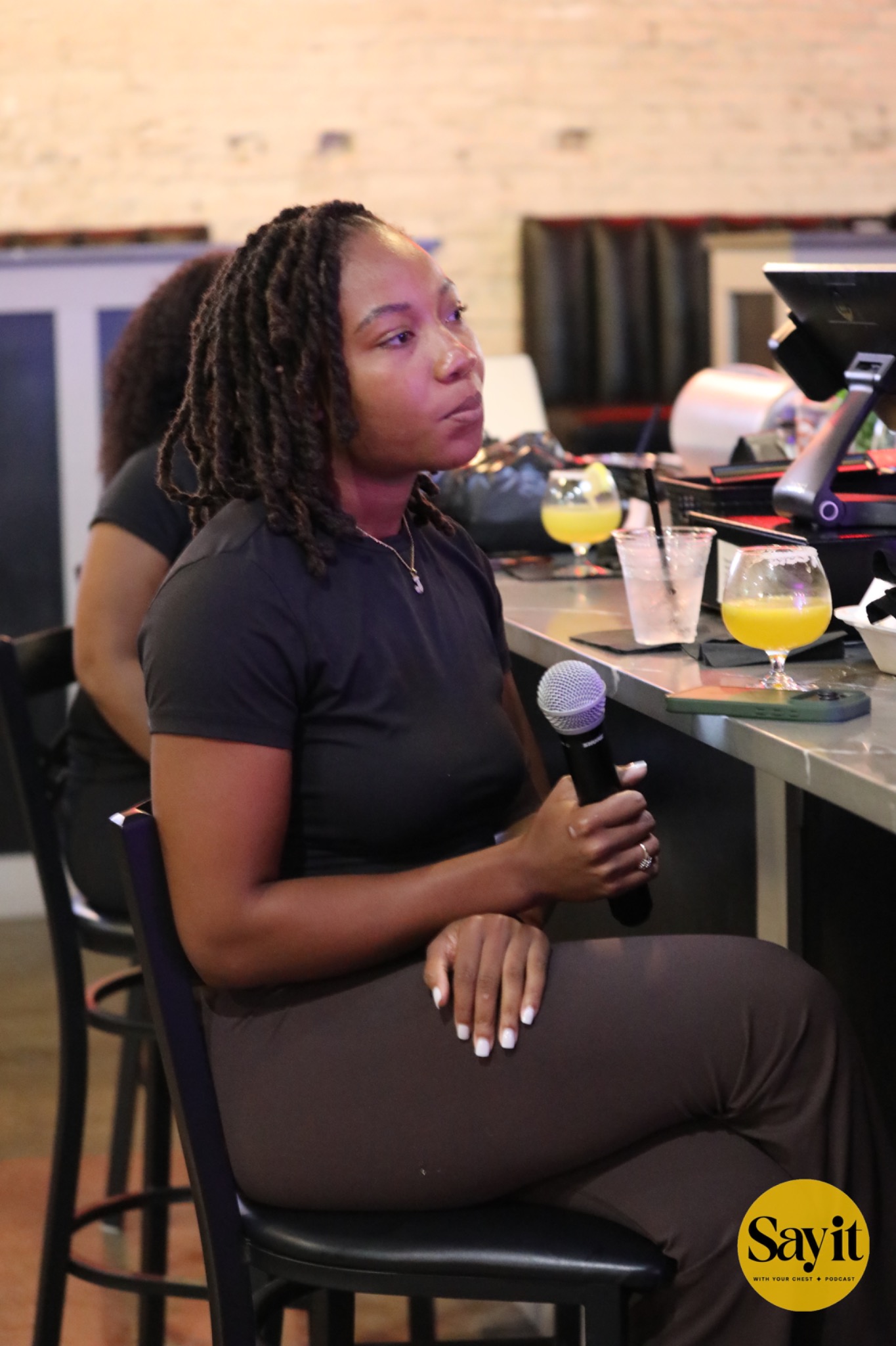 An audience member listening with a microphone in hand